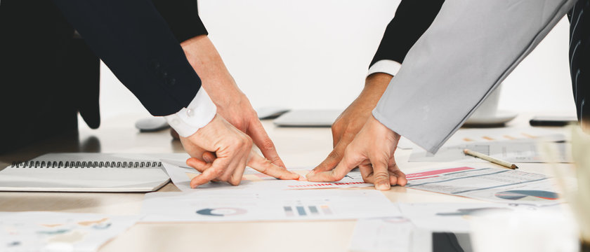 Hands And Fingers Of Businesspeople Pointing At One Point On Meeting Table In Concept Of Aiming Together On Same Business Target