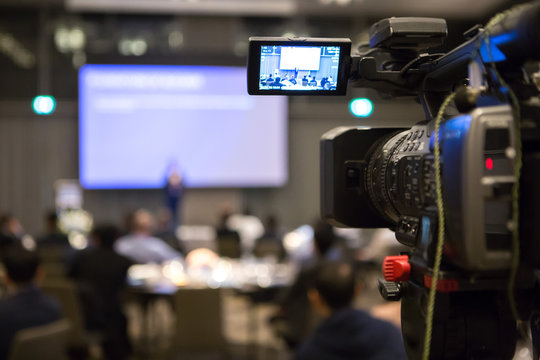 Video camera recording in seminar room on  blurred background