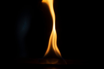 Tongue of fire flame in the dark. Ignition of oxygen in space. Fiery background. Fire of ether in the absence of light. Abstract fire heat background. Single fire. The ignition gel is on.