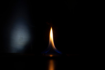 Tongue of fire flame in the dark. Ignition of oxygen in space. Fiery background. Fire of ether in the absence of light. Abstract fire heat background. Single fire. The ignition gel is on.
