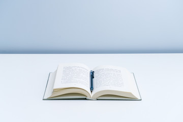An open book on a white desktop