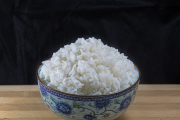 A bowl of rice isolated on black background.