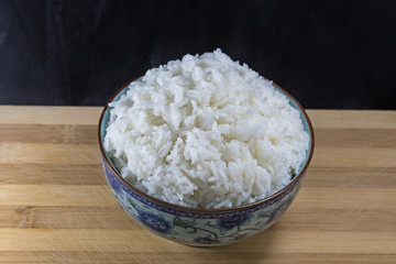 A bowl of rice isolated on black background.