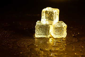 ice cubes on a reflections yellow light.