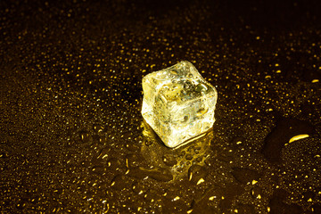 ice cubes on a reflections yellow light.