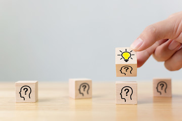 Concept creative idea and innovation. Hand flip over wooden cube block with head human symbol and...