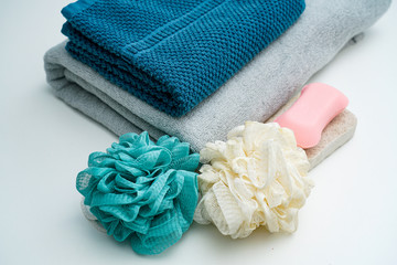 Couple towel and bath ball soap on white table