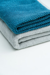 Two lovers towels and bath towels on a white table. Blue towels gray towels bath towels