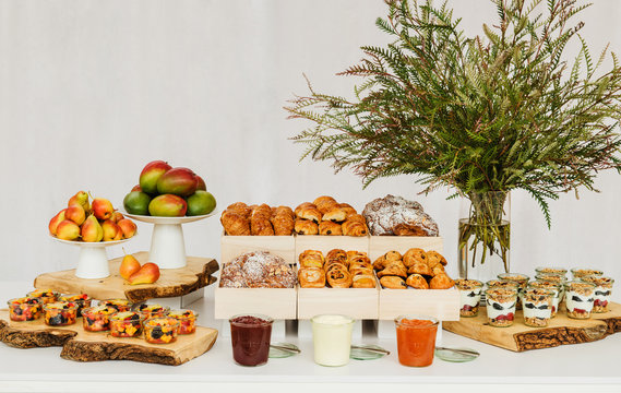 Breakfast buffet with pastries, yogurt, and fruit