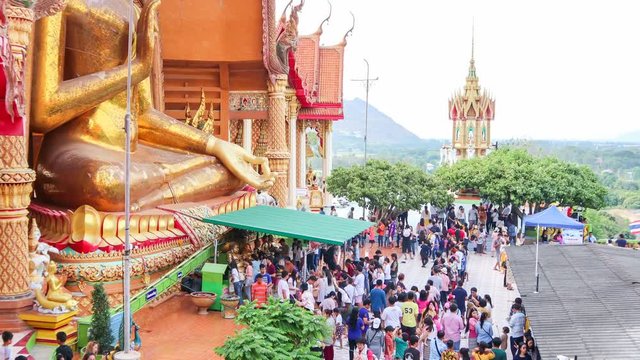 Time lapse of people worships Buddha statue at Tiger Cave Temple (Wat Tham Sua) in Kanchanaburi, Thailand
