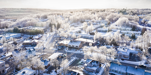 Snowy village in sunny winter day