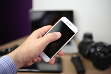 Audio, video and photography business office with equipment such as laptop, mobile phone, headphones and camera with photographic accessories