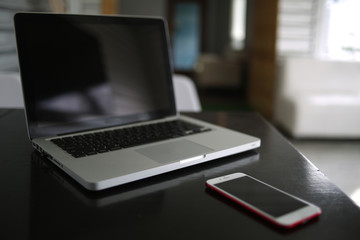 Audio, video and photography business office with equipment such as laptop, mobile phone, headphones and camera with photographic accessories