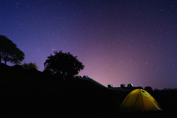 Camping in the hill under the starry night sky.