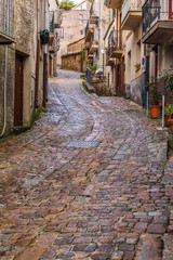 Plakat Italy, Sicily, Palermo Province, Geraci Siculo. Winding narrow cobblestone street in the town of Geraci Siculo.