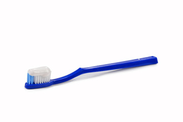 Blue toothbrush with toothpaste in her hand isolated on white background.