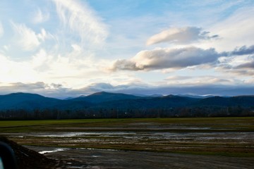 Clouds in the sky, mountains and fields