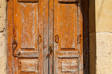 Italy, Sicily, Messina Province, Montalbano Elicona. Peeling paint on old wooden doors in the medieval hill town of Montalbano Elicona.