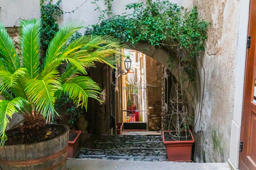 Italy, Sicily, Messina Province, Francavilla di Sicilia. Arched cobblestone desending walkway of town.