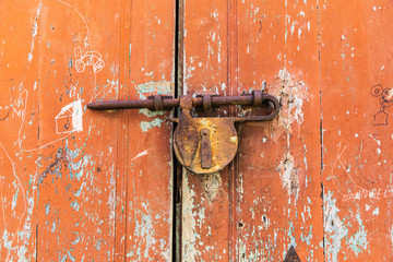 Italy, Sicily, Province of Messina, Novara di Sicilia. Rusted lock on an old door in the medieval hill town of Francavilla di Sicilia.