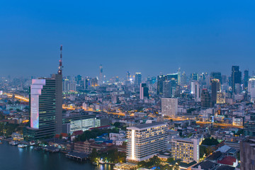 Fototapeta na wymiar Bangkok city skyline in downtown district at night blue hour time.