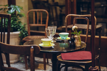 view of restaurant cafe table with tea mugs and flower