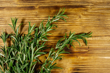 Fresh rosemary herbs on a wooden table. Top view