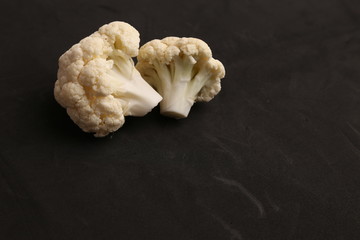 Pieces of raw cauliflower in color background