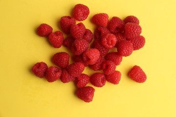 delicious raspberries in colorful background