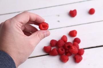 delicious raspberries in colorful background
