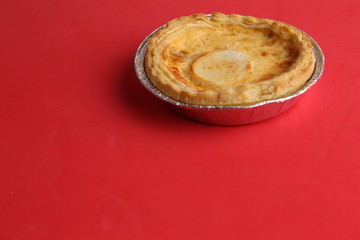 Delicious three cheese quiche in colored background