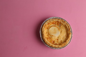 Delicious three cheese quiche in colored background