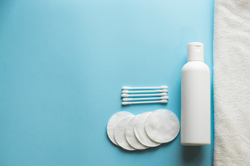 Composition with skin care products on blue background with a copy space