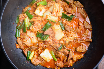 Stir-fried pork with kimchi in cooking pan, homemade Korean food