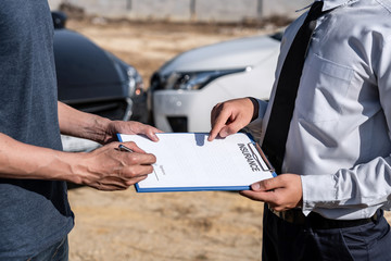 Insurance Agent examining car crash and customer assessed negotiation, checking and signing on report claim form process after accident collision, Accident and insurance concept