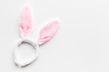 Easter bunny concept. Toy rabbit's ears for head on white background top-down copy space
