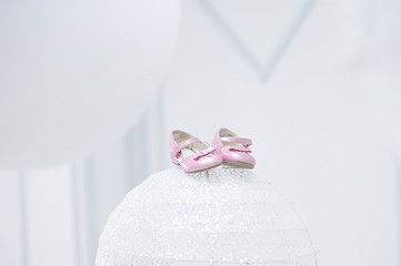 pink little baby shoes on a white light background