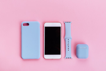 Up to date technology.Top view of diverse personal accessory laying on the pink background