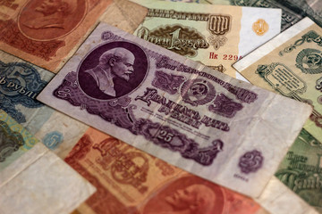 A lot of Soviet paper money, USSR banknotes of different denominations. Old and inactive money. Background