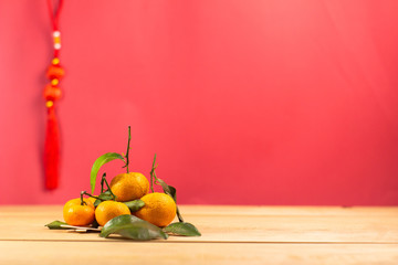 Fresh mandarin orange with leaf on wooden, white background.selective focus