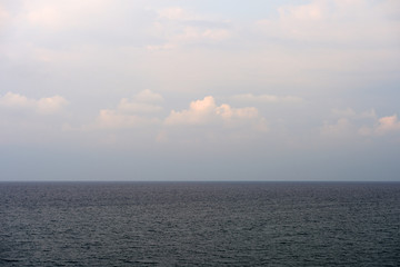 Overcast sky over the sea on a summer evening near the coast of Sicily. Natural background