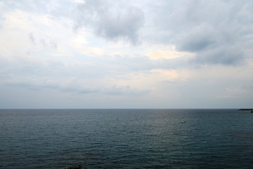 Overcast sky over the sea on a summer evening near the coast of Sicily. Natural background