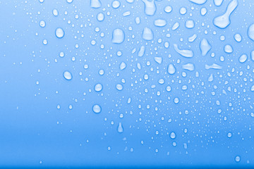 Drops of water on a color background. Selective focus. Blue. Toned