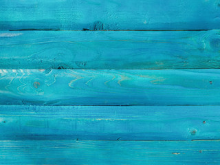 Natural wood planks making a wall or ground colored with blue paint for an interesting look with rough surface texture