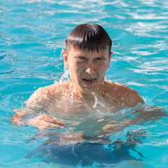 man resting by the pool on a summer day