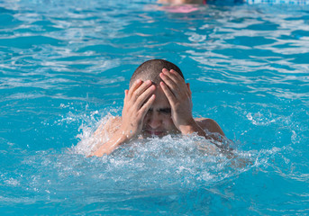 man resting by the pool on a summer day