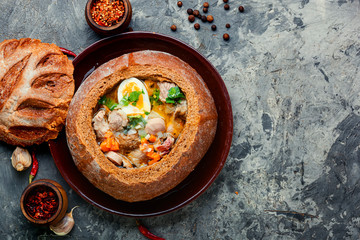 Polish soup zurek in bread pot