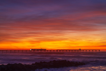 Nice colorful clouds after sunset at a pier over the Pacific Ocean. Ocean Beach neighborhood of San Diego, California.