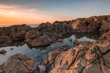 Cala Domestica Beach, natural pools at sunset in long exposure, Buggerru, Sardinia