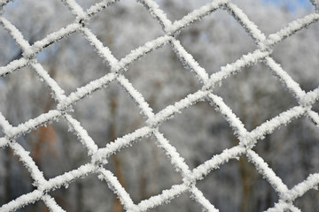 Chainlink fence with rime in winter time